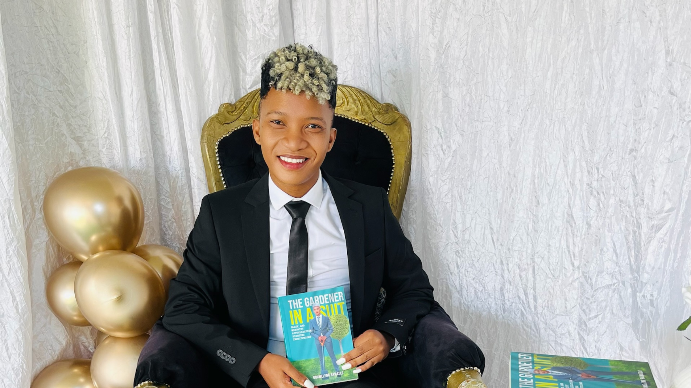 Odumeleng Ramatlo sits with a copy of his new book