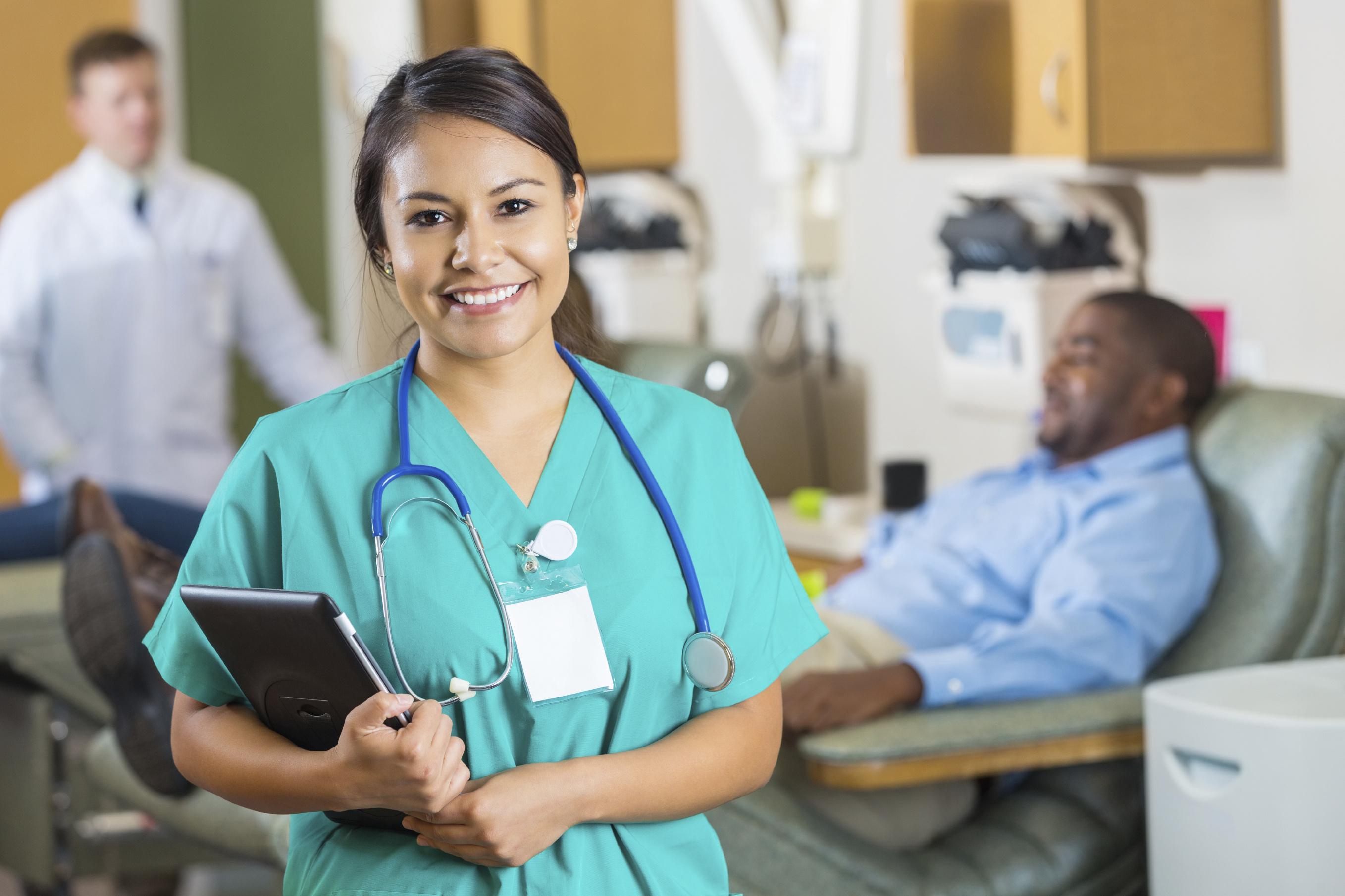 Friendly young nurse holding an iPad