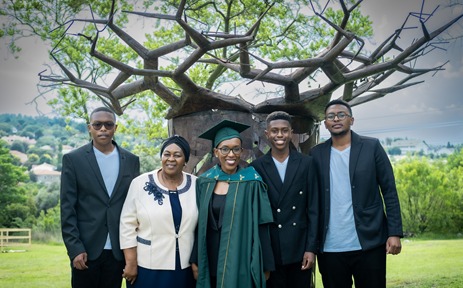 MBA graduate ‘KG’ Mangwale flanked by proud mom and her three sons, celebrates her graduation from Henley Business School Africa’s flexible and family-friendly MBA.
